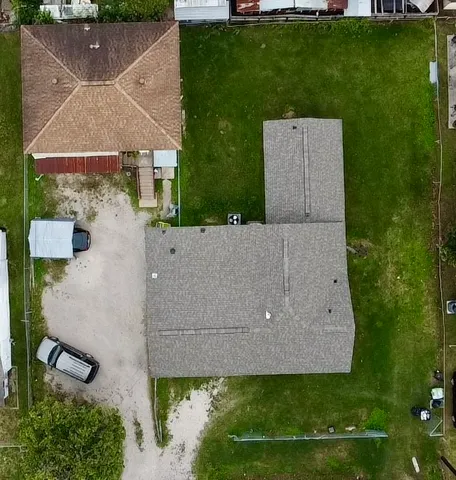 an aerial view of a house with a yard