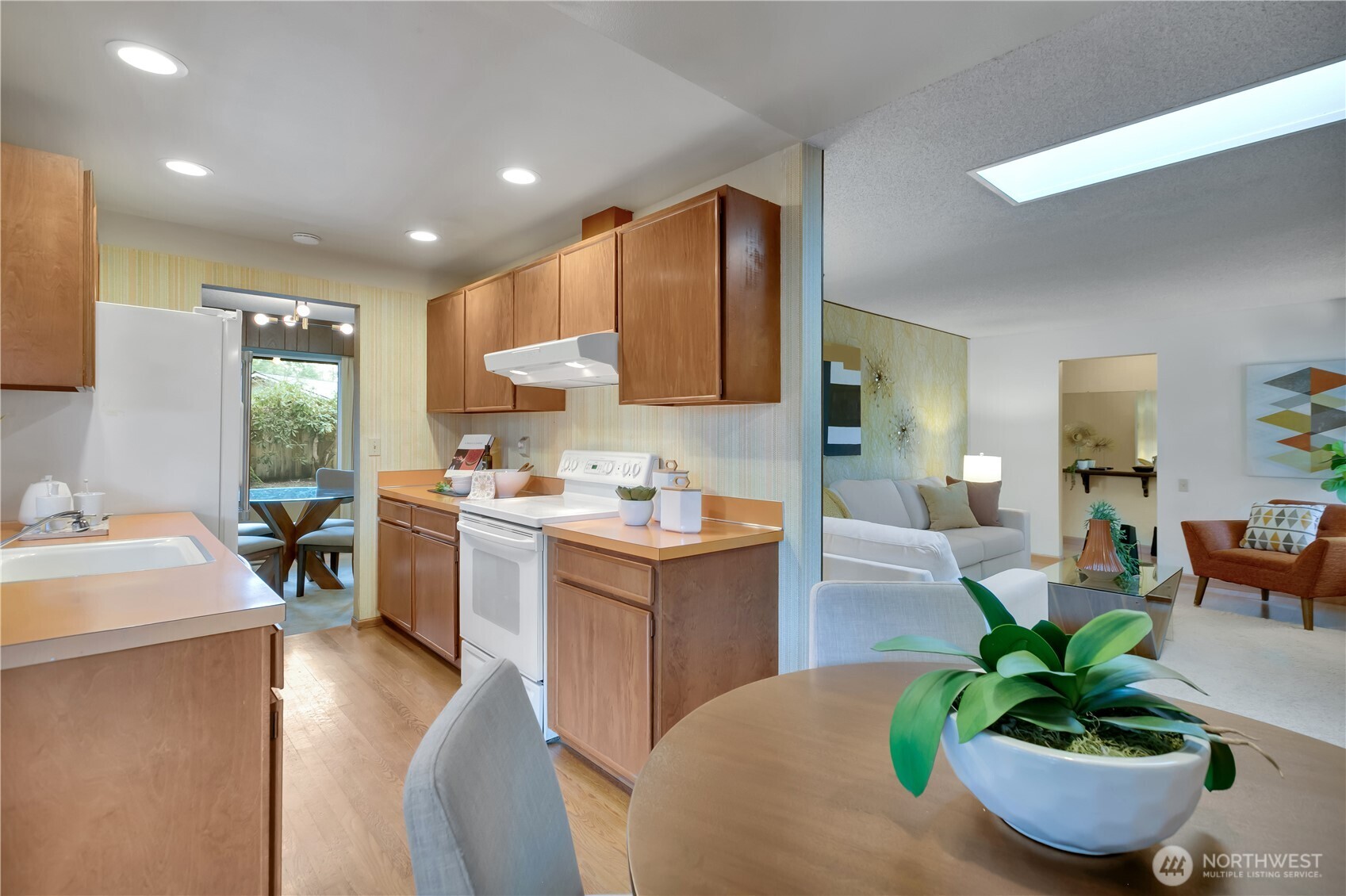 2005 Camas Court Southeast Renton, WA 98055 - Photo 9 of 31 a kitchen with a table chairs sink and cabinets
