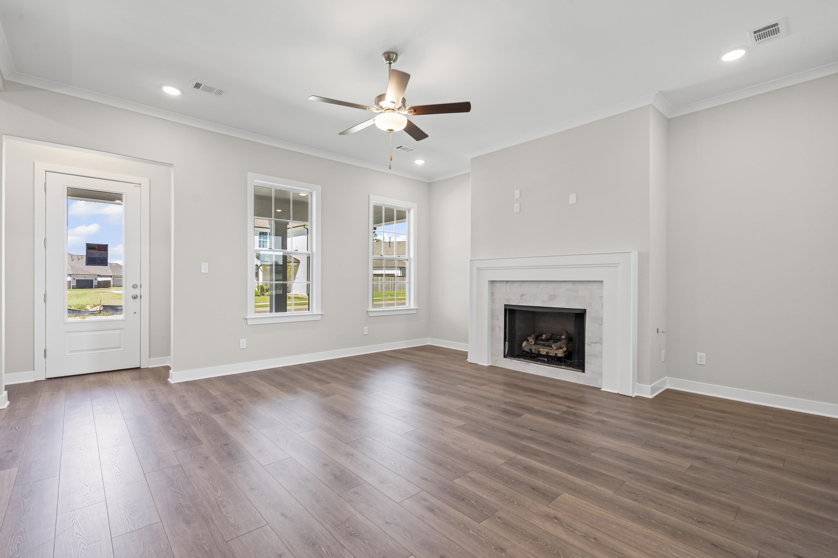 4824 Lyla Lane Collierville, TN 38017 - Photo 11 of 32 a view of an empty room with wooden floor fireplace and a window