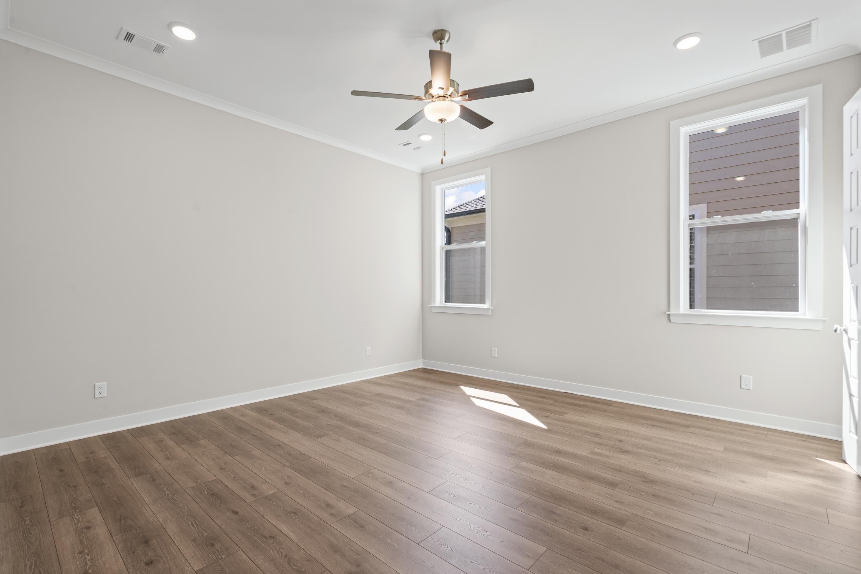 4824 Lyla Lane Collierville, TN 38017 - Photo 17 of 32 an empty room with wooden floor chandelier fan and windows