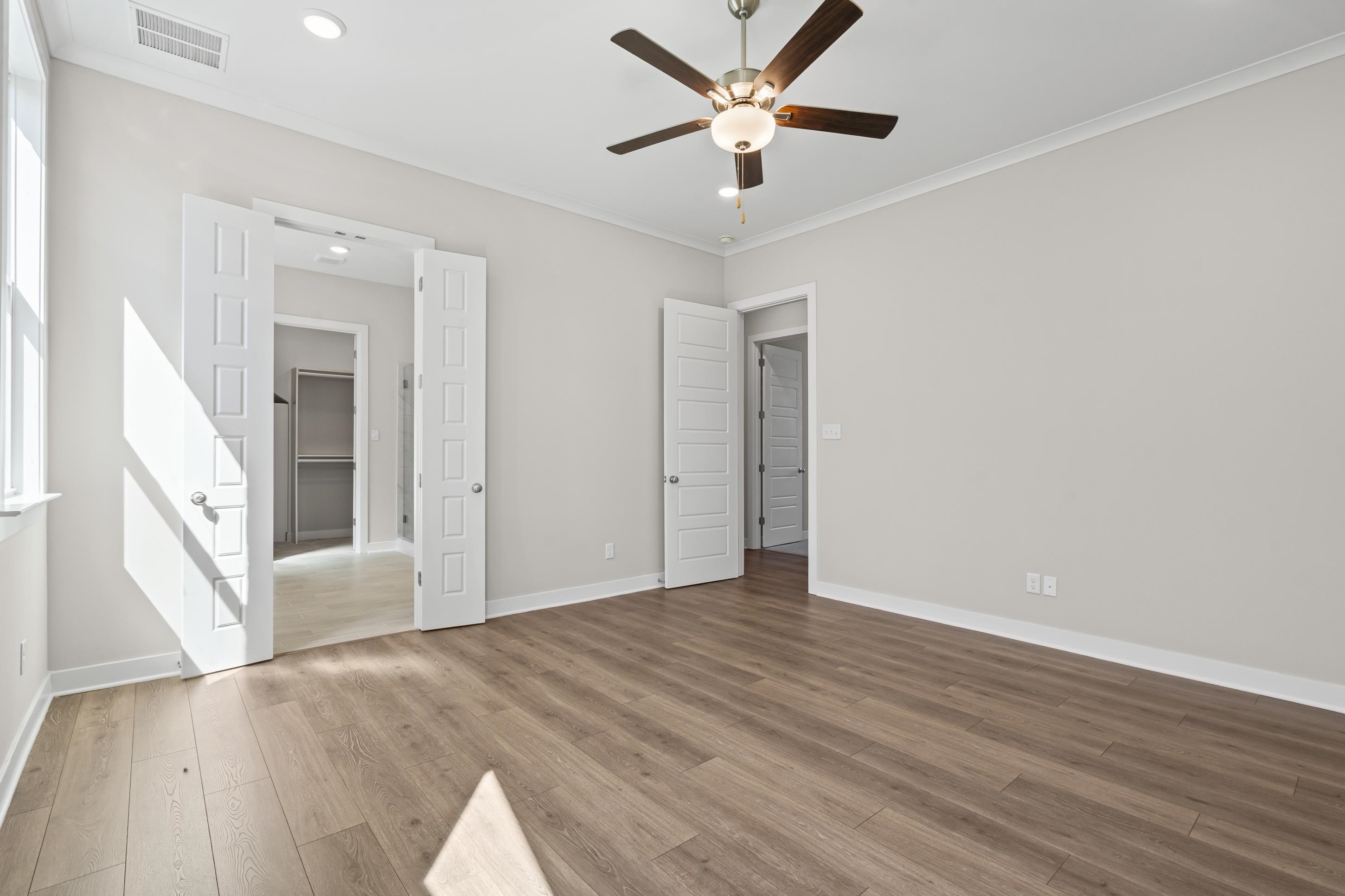 4824 Lyla Lane Collierville, TN 38017 - Photo 18 of 32 a view of an empty room with wooden floor and a ceiling fan