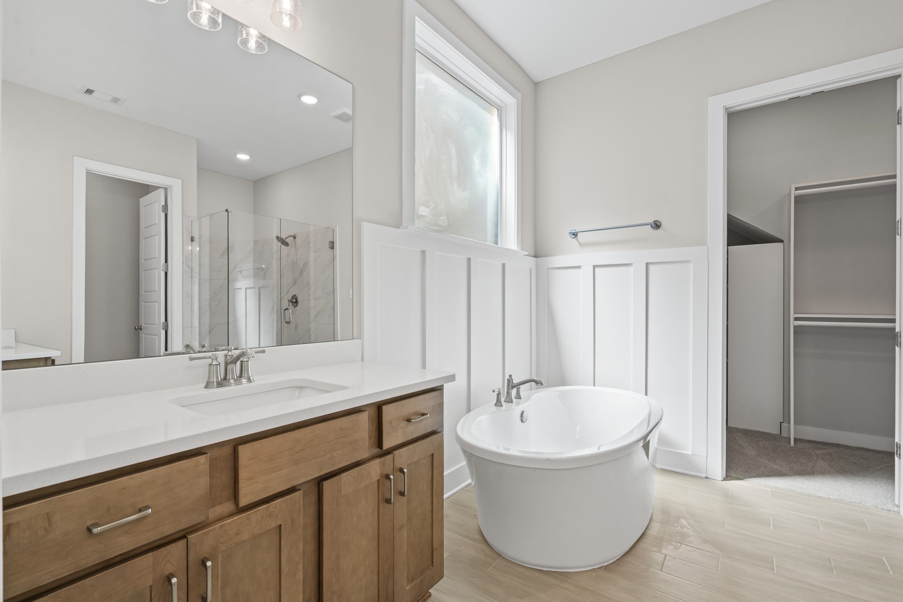 4824 Lyla Lane Collierville, TN 38017 - Photo 19 of 32 a bathroom with a tub sink and mirror