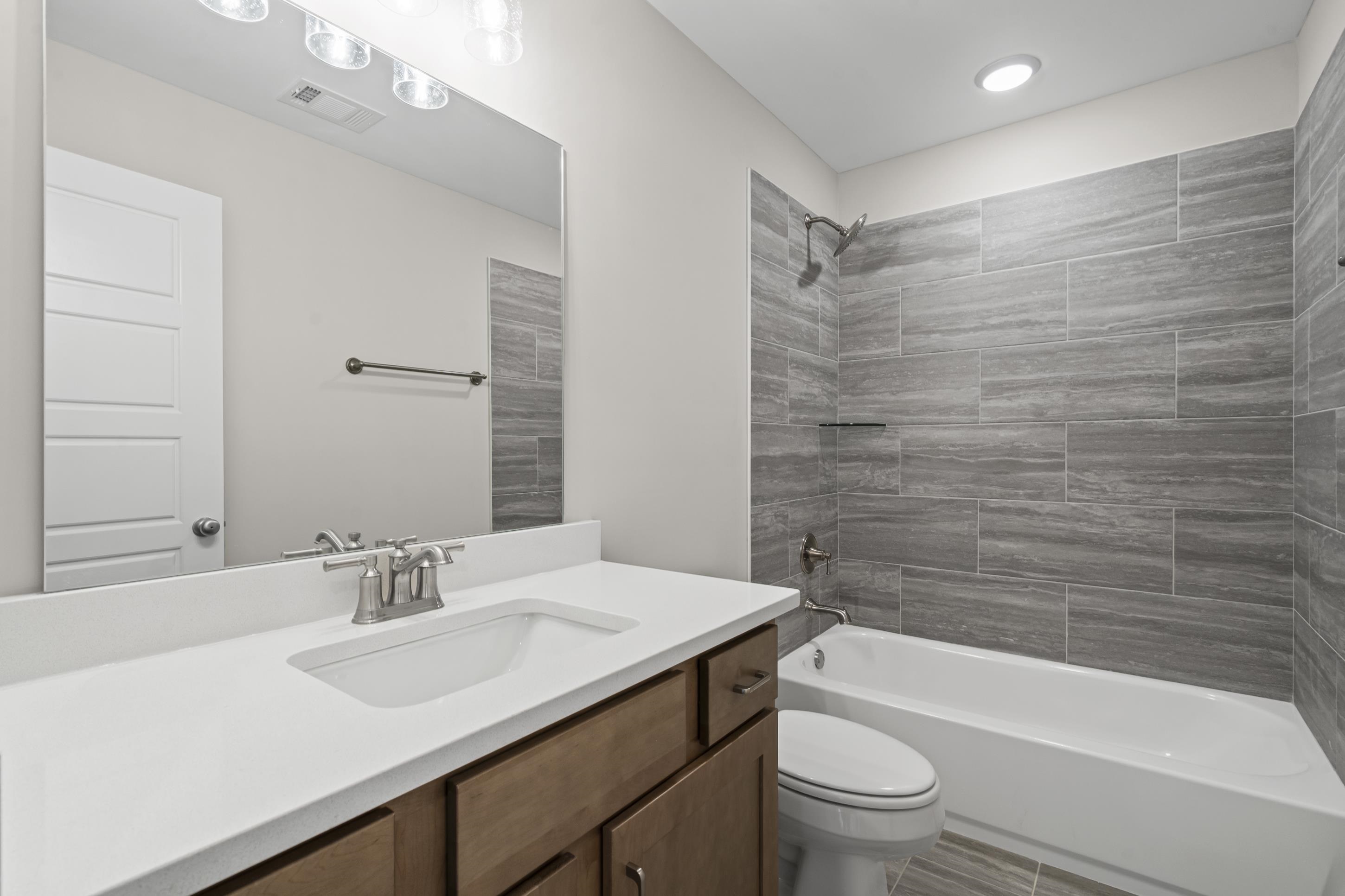 4824 Lyla Lane Collierville, TN 38017 - Photo 26 of 32 a bathroom with a sink a toilet and shower