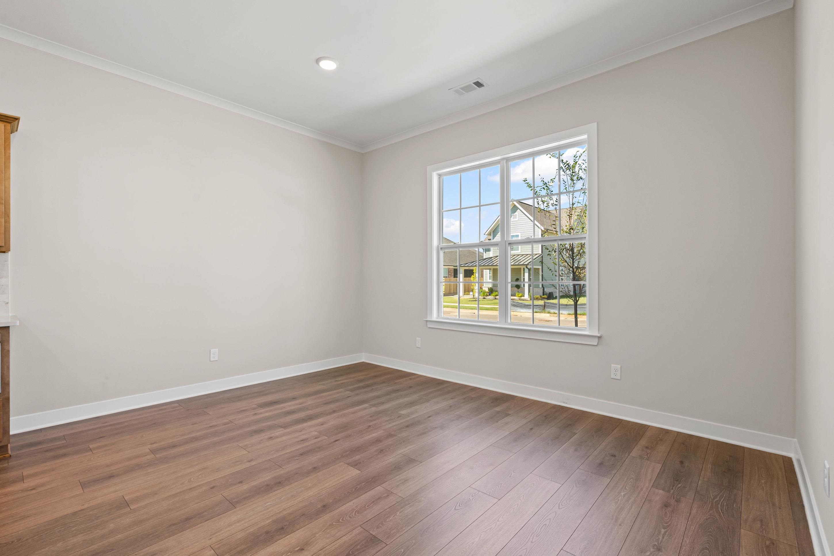 4824 Lyla Lane Collierville, TN 38017 - Photo 9 of 32 a view of an empty room with wooden floor and a window