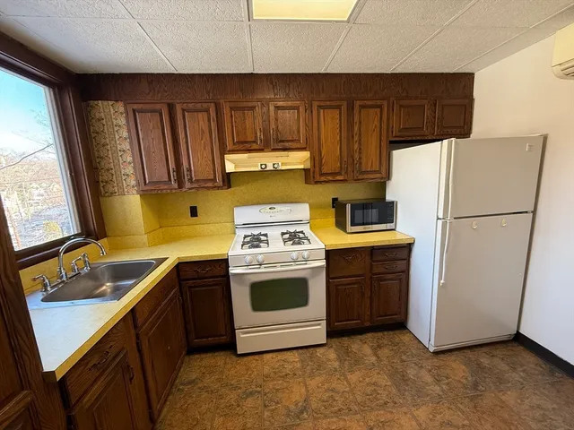 a kitchen with a refrigerator sink and stove