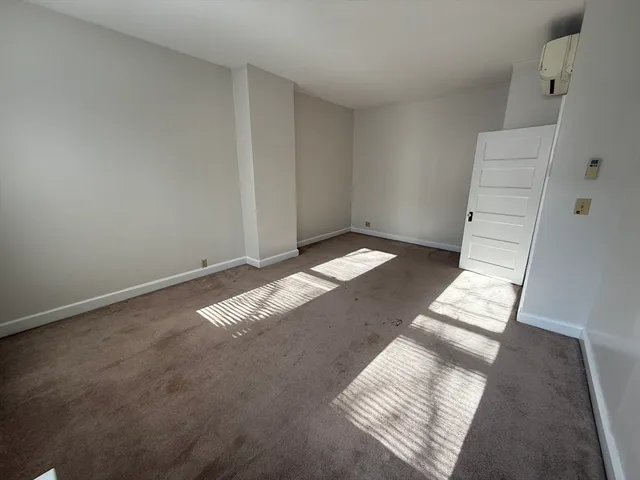 a view of an empty room and stairs