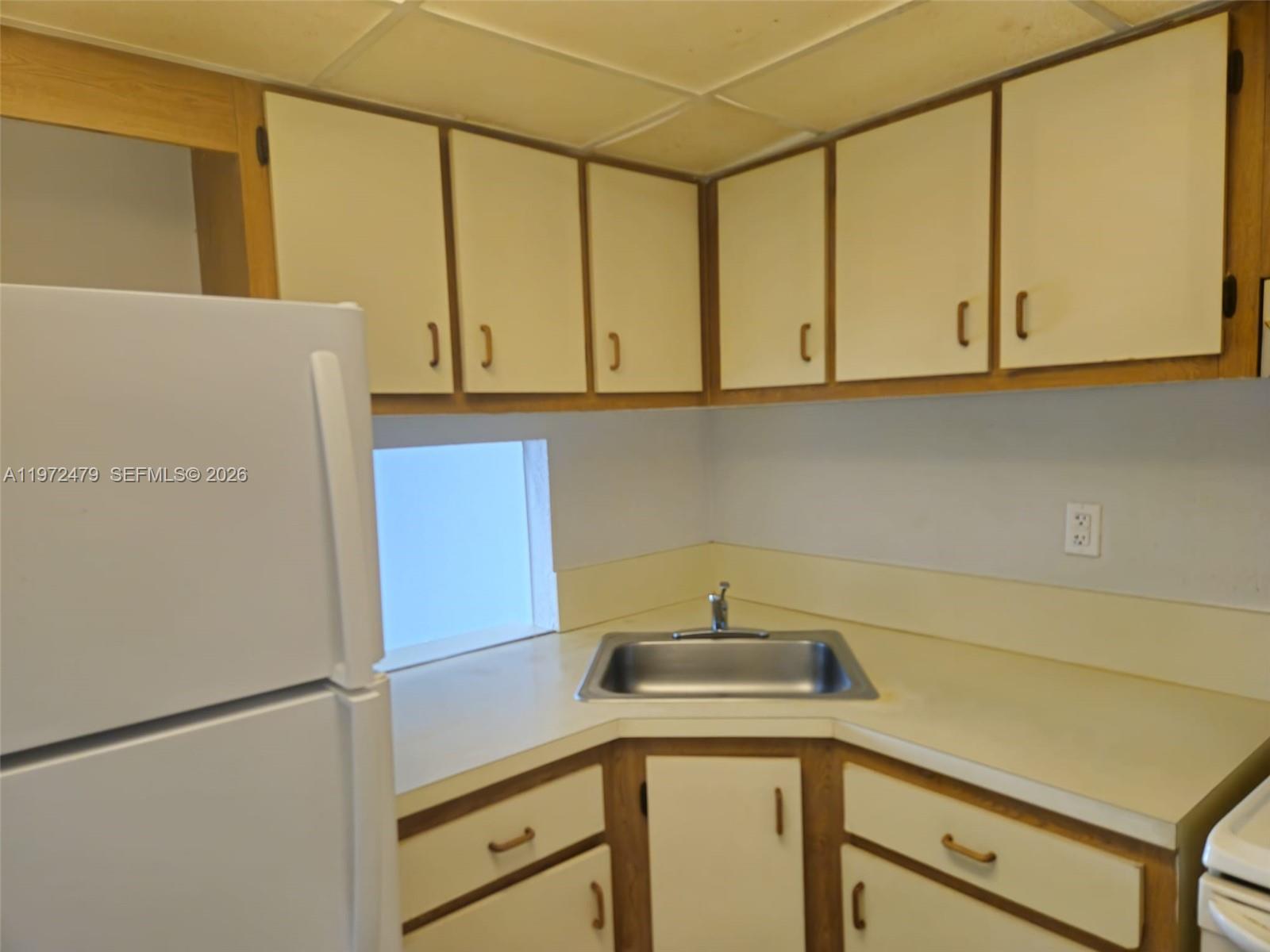a kitchen with a refrigerator and a sink