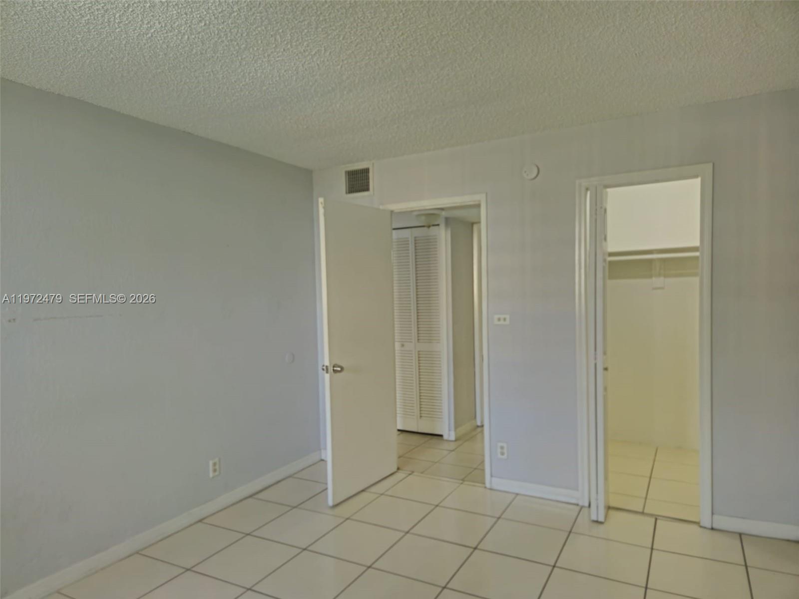 4550 Northwest 9th Street, Unit 704E Miami, FL 33126 - Photo 5 of 21 a view of an empty room and window