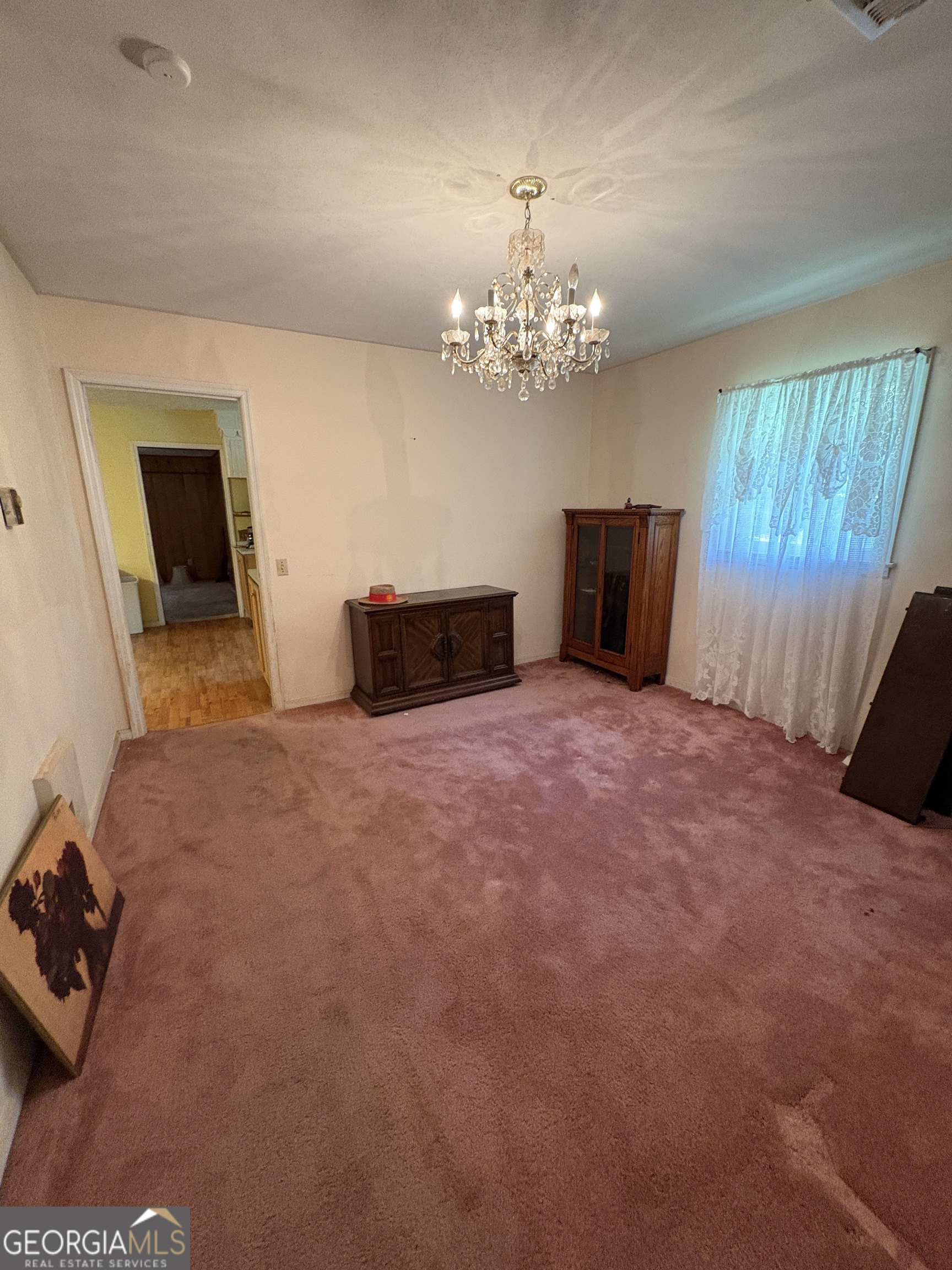 5735 Fitzgerald Street Eastman, GA 31023 - Photo 15 of 22 a big room with windows and a chandelier