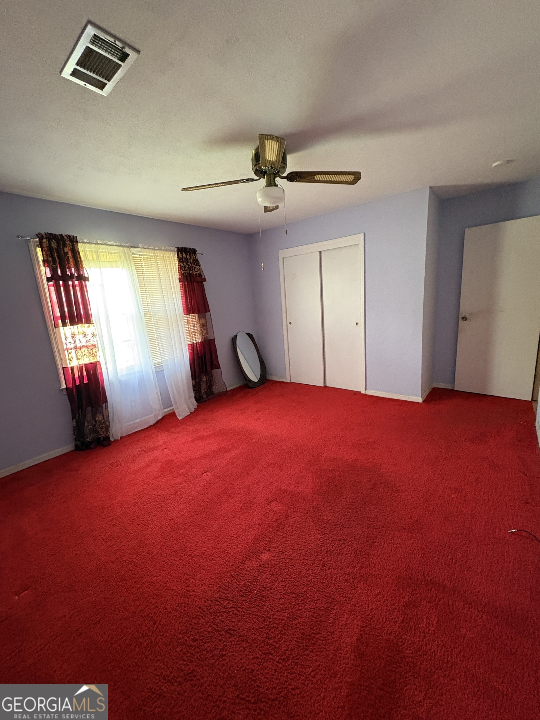5735 Fitzgerald Street Eastman, GA 31023 - Photo 19 of 22 a bedroom with a bed and a chandelier