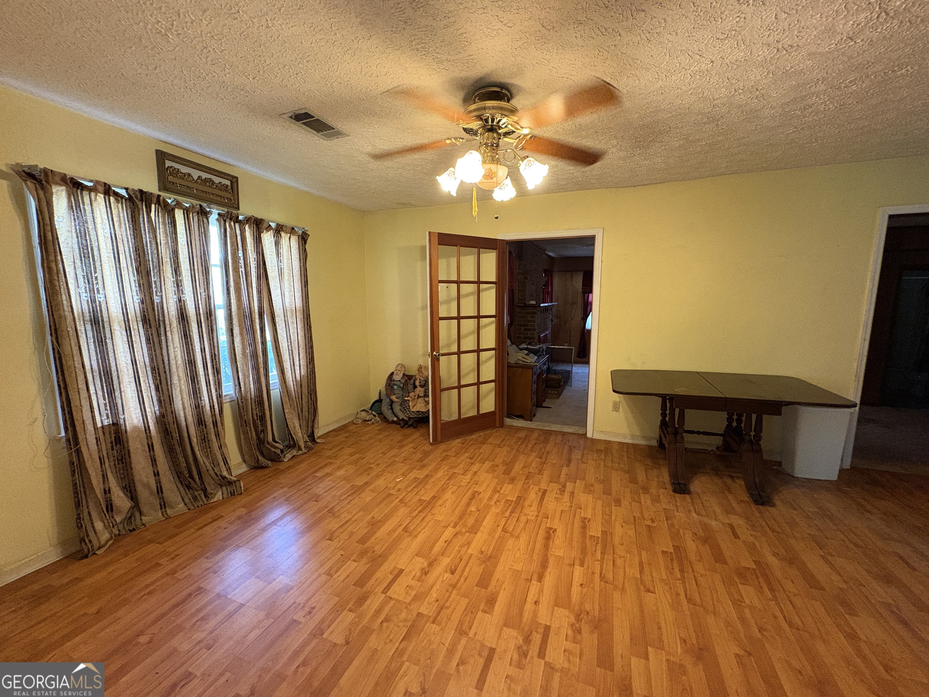 5735 Fitzgerald Street Eastman, GA 31023 - Photo 8 of 22 wooden floor in an empty room with a window