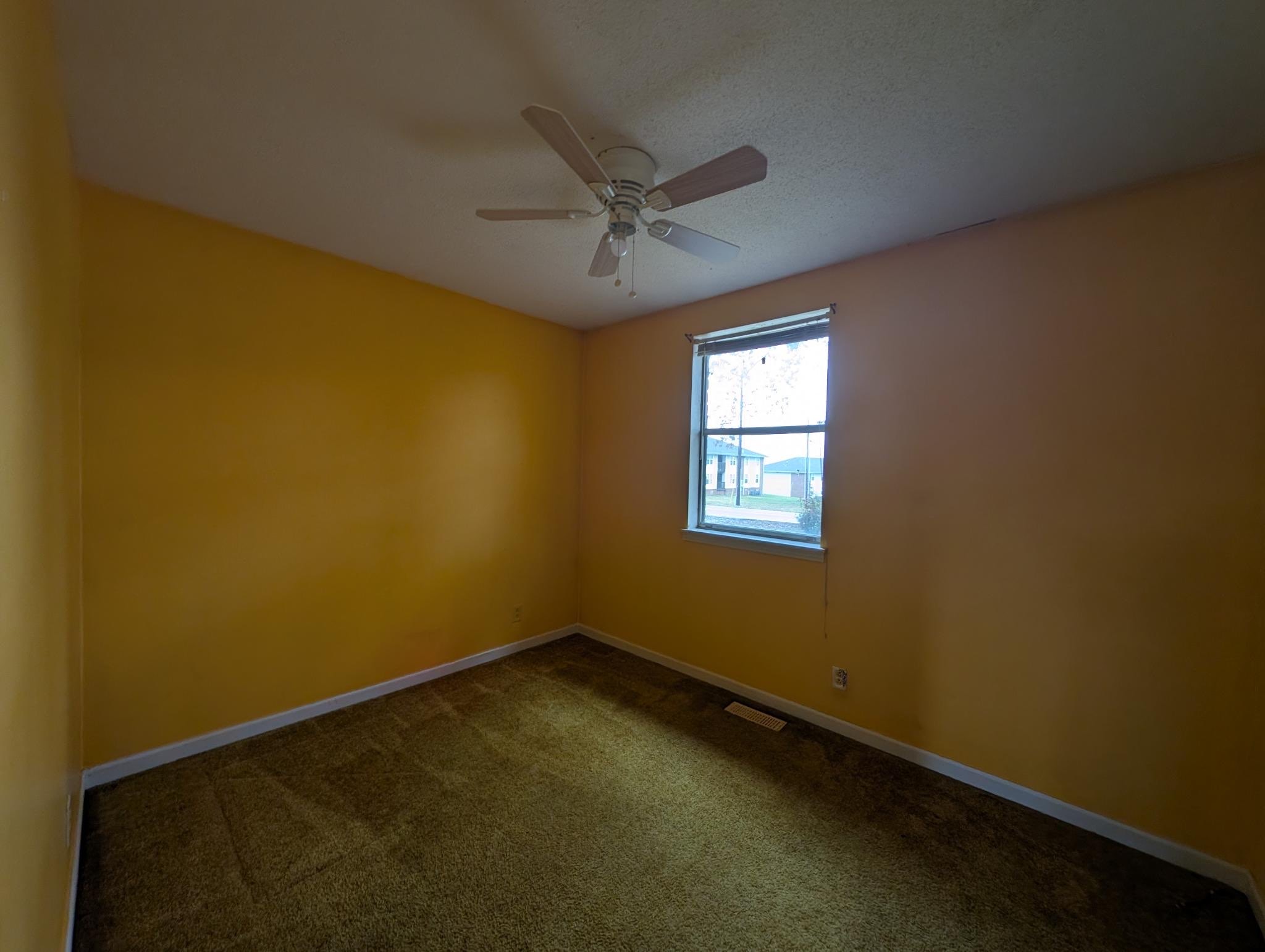 2622 Union Hall Road Clarksville, TN 37040 - Photo 8 of 12 an empty room with a window and a ceiling fan
