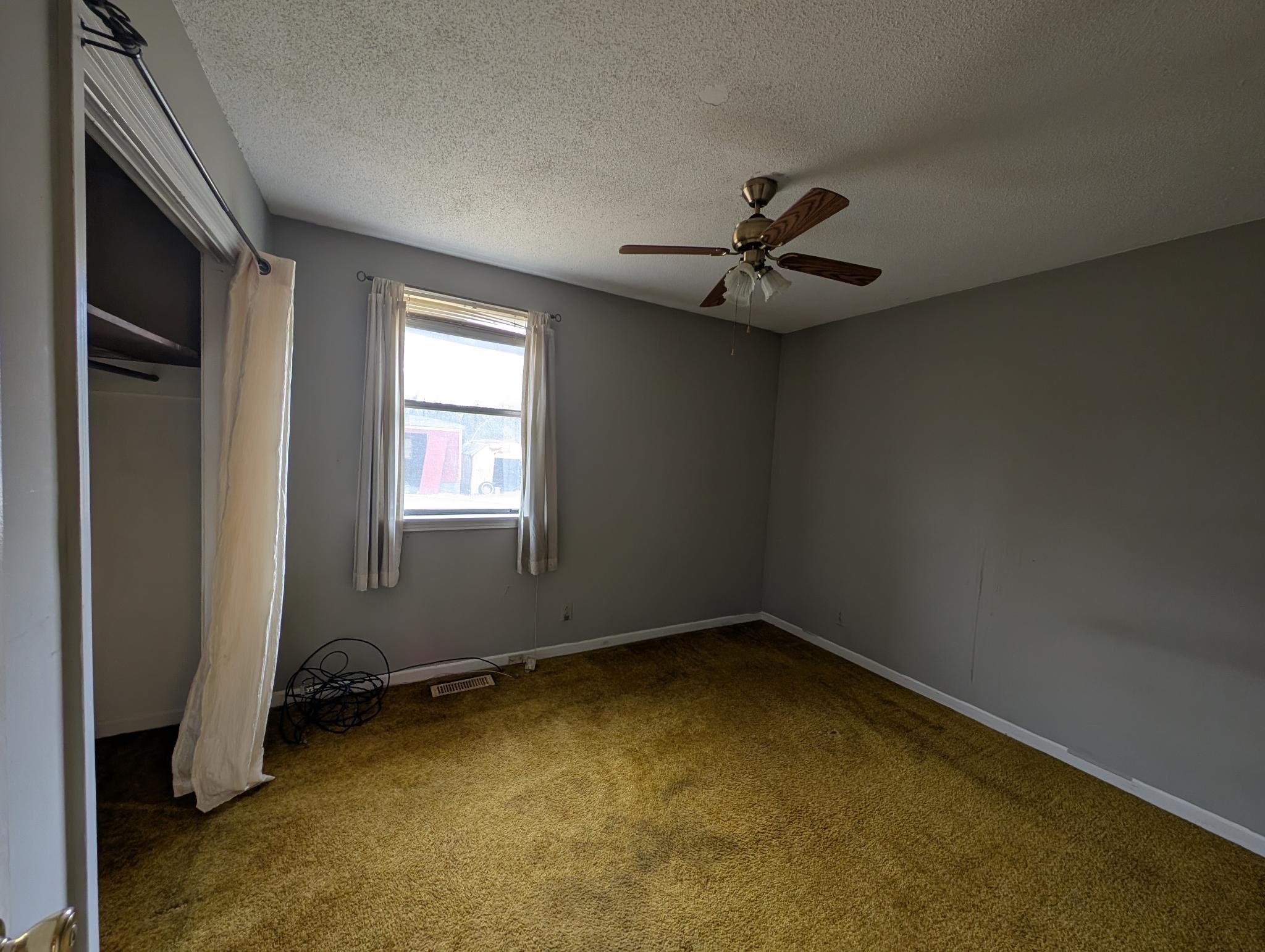 2622 Union Hall Road Clarksville, TN 37040 - Photo 10 of 12 an empty room with a window and a ceiling fan