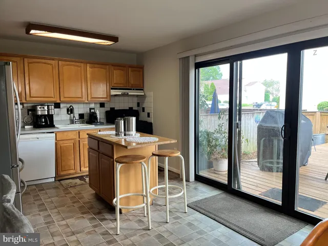 a kitchen with a stove a sink and a refrigerator