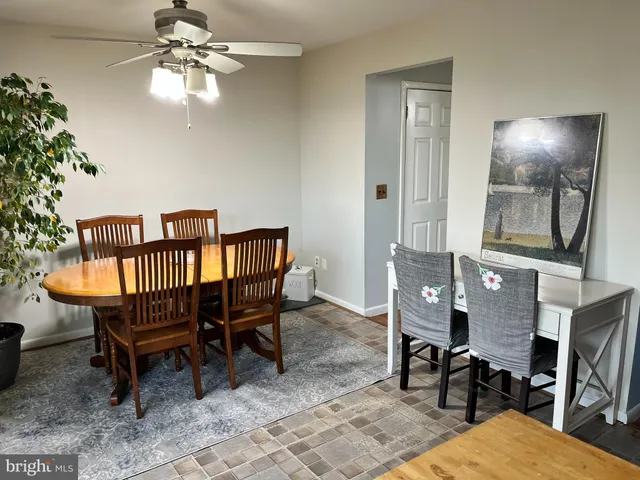 a view of a livingroom with furniture and a dining table