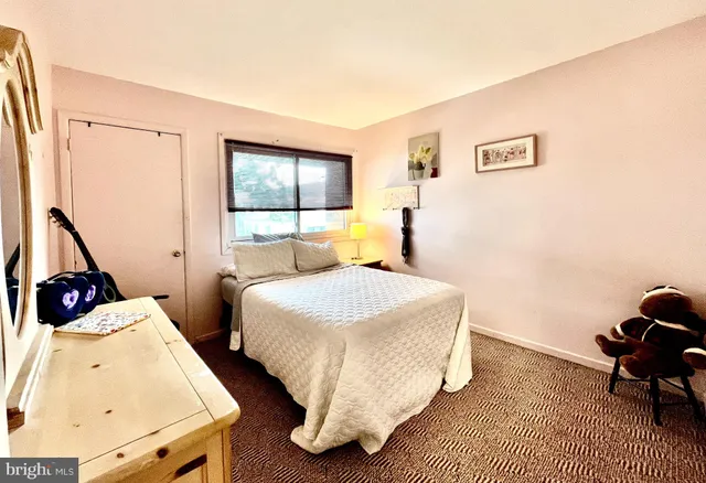 a bedroom with two beds and a window