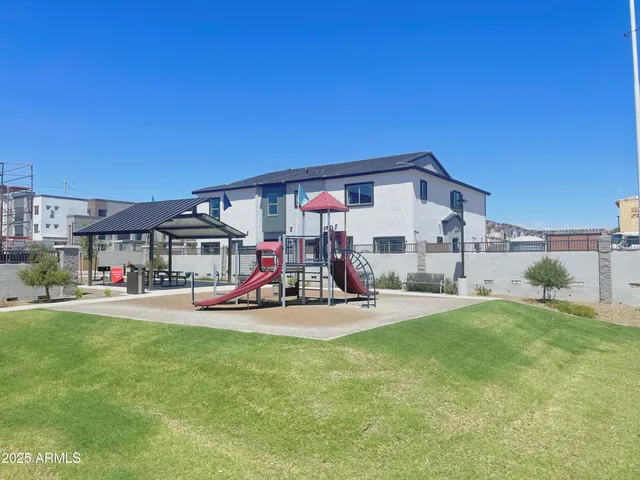a view of a house with a big yard and potted plants