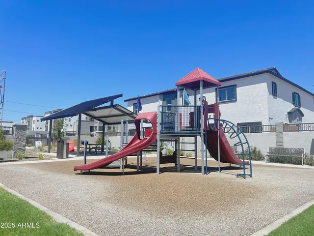 a roof deck with a table and chairs