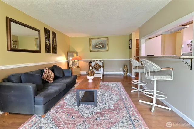 a living room with furniture a rug and a flat screen tv