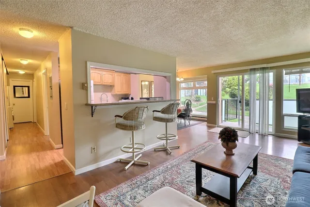 a view of a dining room with furniture a chandelier and window