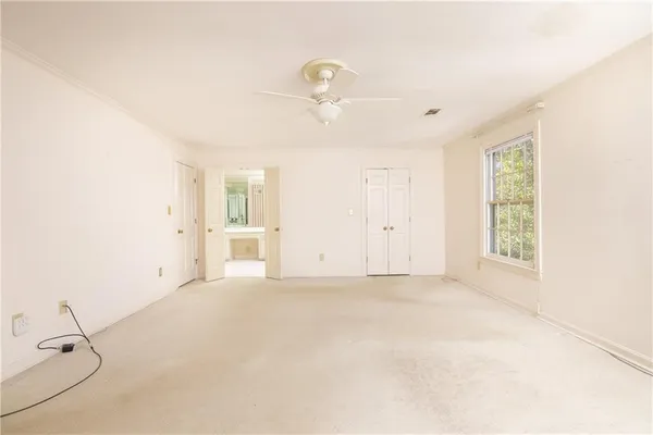 a living room with a large window and furniture