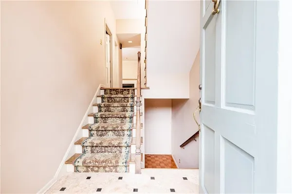 a view of staircase with white walls
