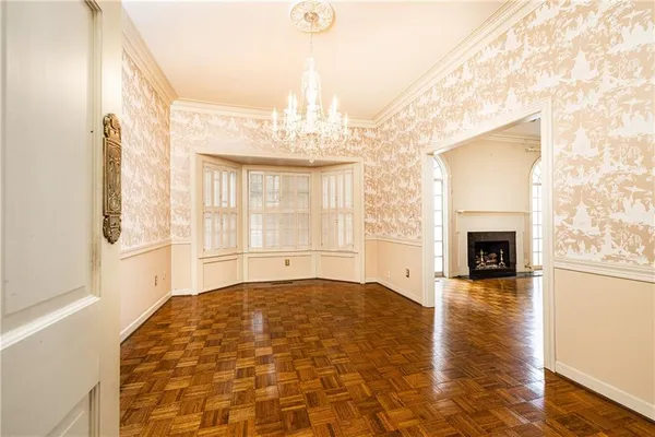 a view of a livingroom with wooden floor and a fireplace