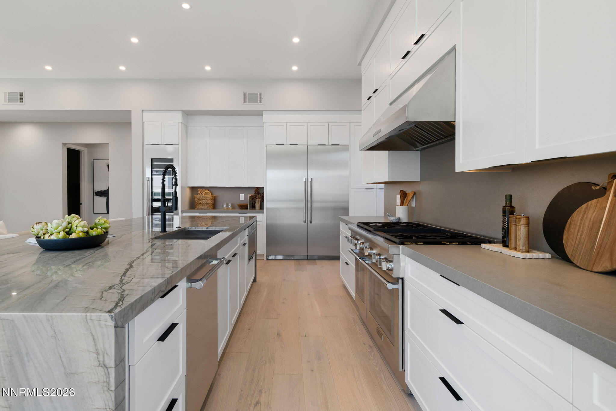 42 Campolina Street Reno, NV 89511 - Photo 10 of 52 a kitchen with stainless steel appliances granite countertop a sink a stove and a wooden floors