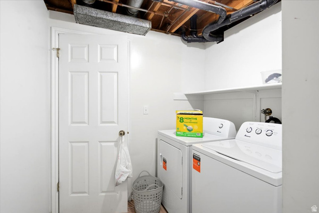 2455 South Bluff Road Syracuse, UT 84075 - Photo 24 of 32 Dedicated laundry room featuring full-size front-load washer and electric dryer with convenient upper shelving for storage, white six-panel entry door, and neutral wall finishes
