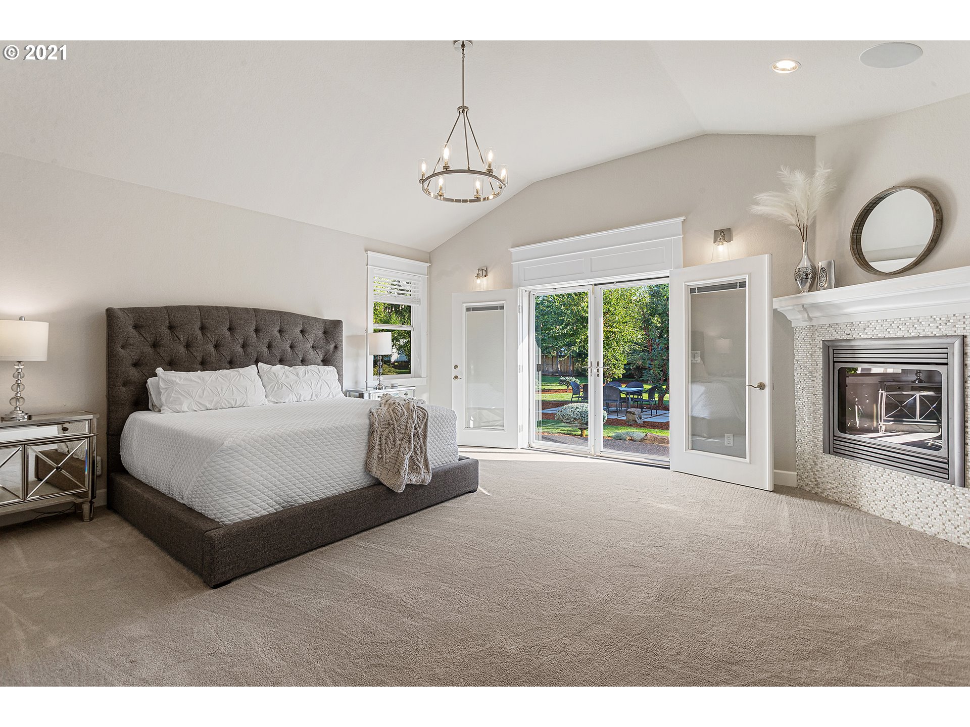 15849 South Harding Road Oregon City, OR 97045 - Photo 11 of 32 a spacious bedroom with a bed ceiling fan and a large window