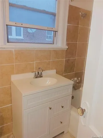 a bathroom with a sink and cabinets