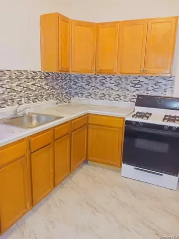a view of kitchen with stainless steel appliances granite countertop cabinets and a sink