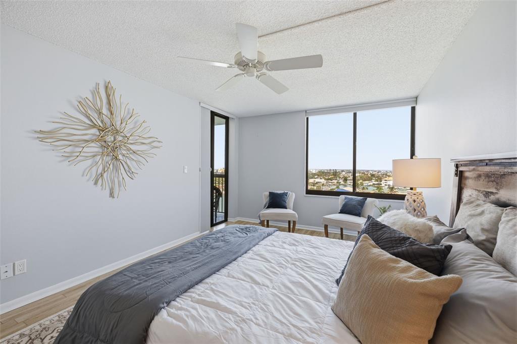 9495 Blind Pass Road, Unit 905 St. Pete Beach, FL 33706 - Photo 13 of 59 a bedroom with a large bed and a window