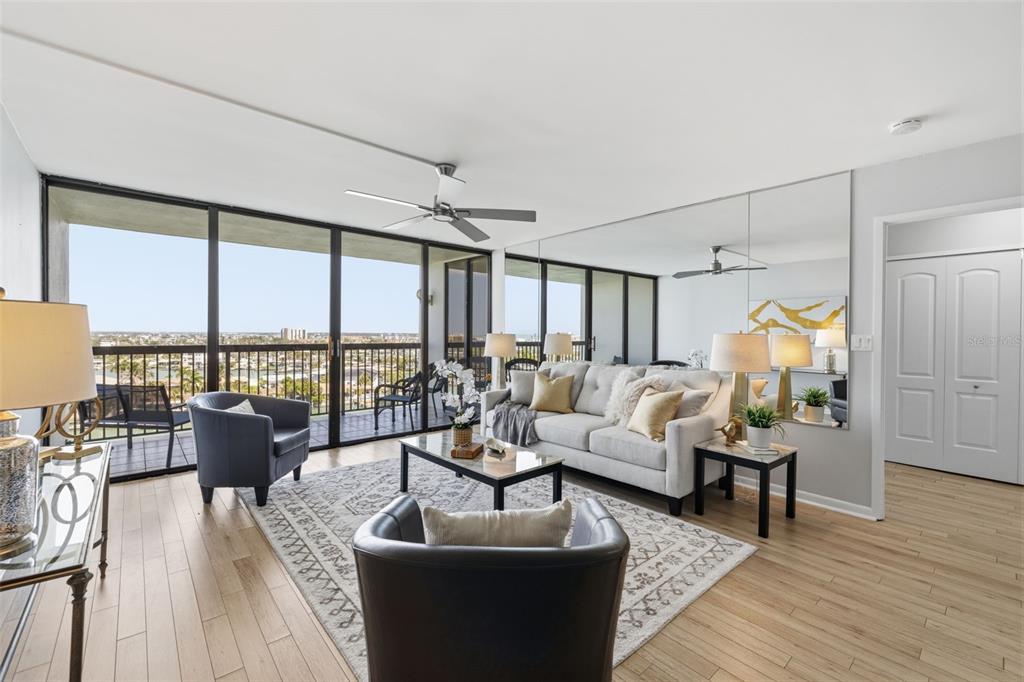 9495 Blind Pass Road, Unit 905 St. Pete Beach, FL 33706 - Photo 2 of 59 a living room with furniture and a large window