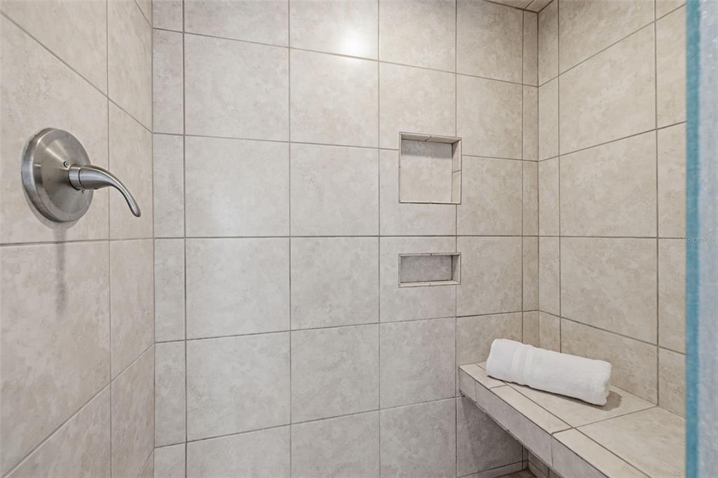 9495 Blind Pass Road, Unit 905 St. Pete Beach, FL 33706 - Photo 22 of 59 a bathroom with a shower