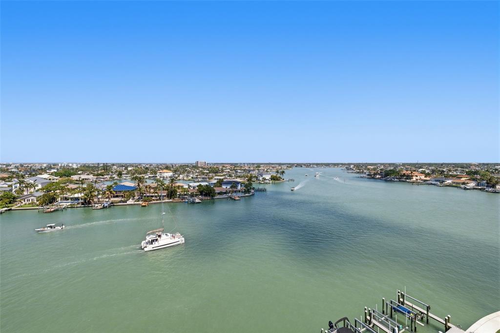 9495 Blind Pass Road, Unit 905 St. Pete Beach, FL 33706 - Photo 29 of 59 an aerial view of a ocean with large trees