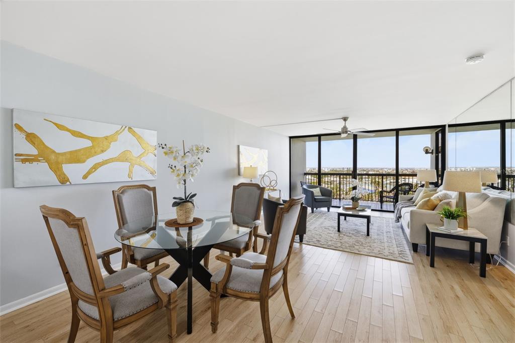 9495 Blind Pass Road, Unit 905 St. Pete Beach, FL 33706 - Photo 3 of 59 a dining room with furniture and wooden floor