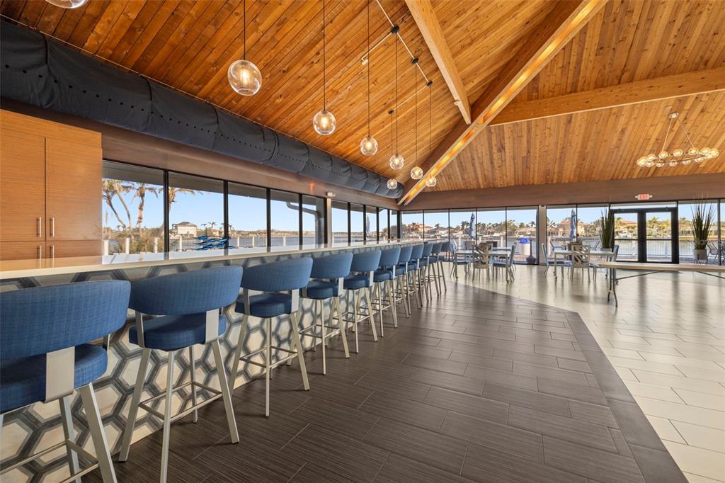 9495 Blind Pass Road, Unit 905 St. Pete Beach, FL 33706 - Photo 48 of 59 a dining room with furniture window and wooden floor
