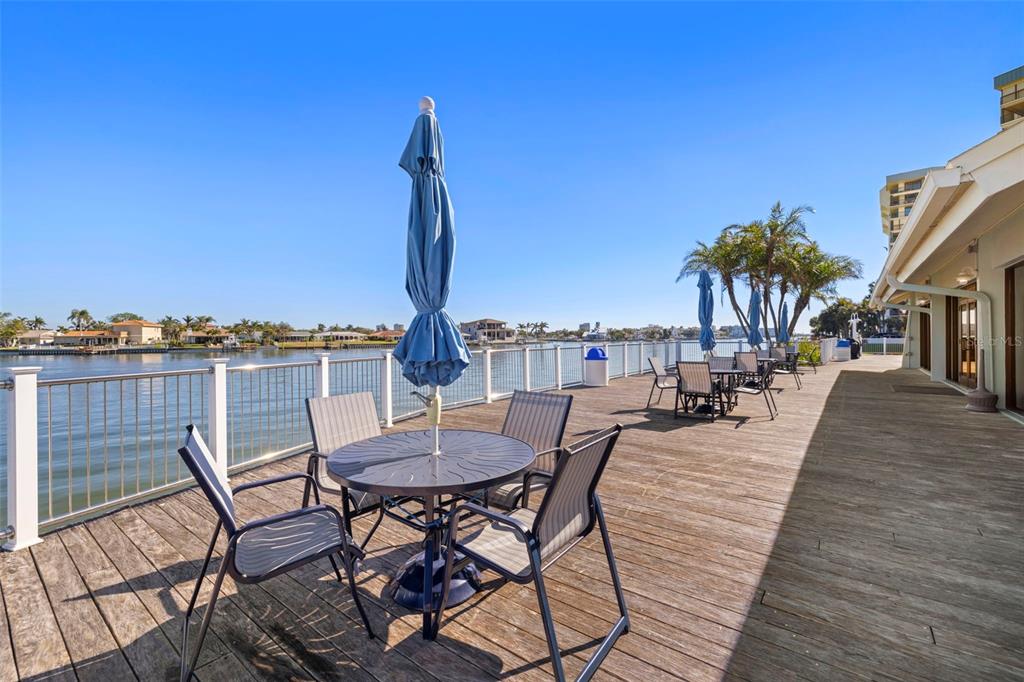 9495 Blind Pass Road, Unit 905 St. Pete Beach, FL 33706 - Photo 52 of 59 a view of a chairs and table on the terrace