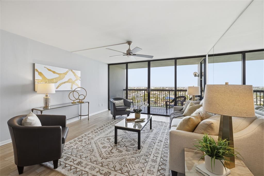 9495 Blind Pass Road, Unit 905 St. Pete Beach, FL 33706 - Photo 6 of 59 a living room with furniture and a large window
