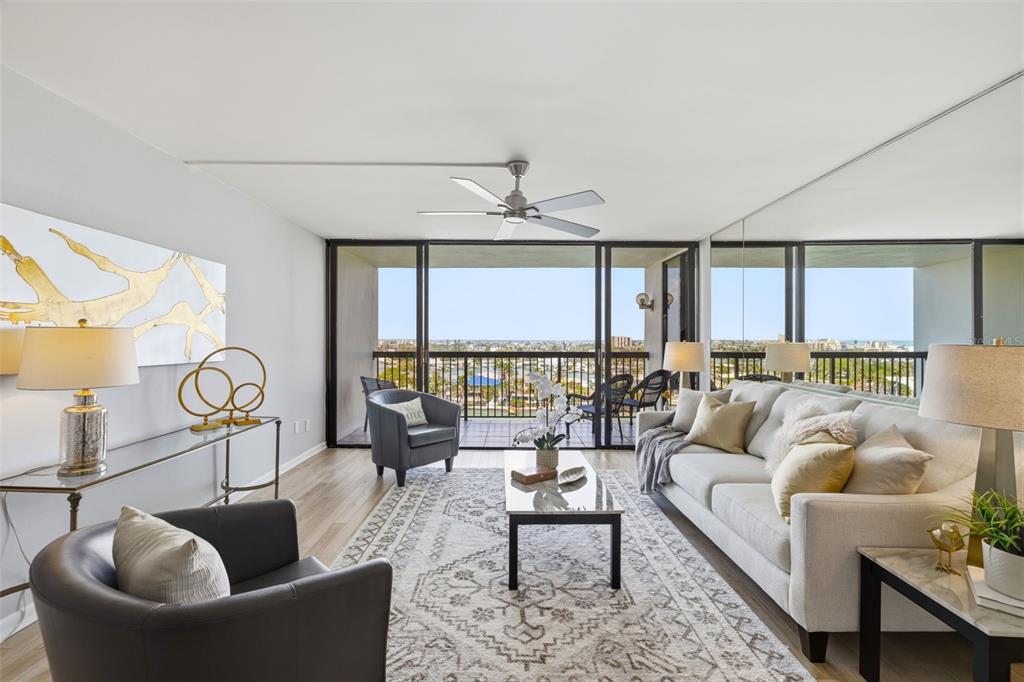9495 Blind Pass Road, Unit 905 St. Pete Beach, FL 33706 - Photo 7 of 59 a living room with furniture and a large window