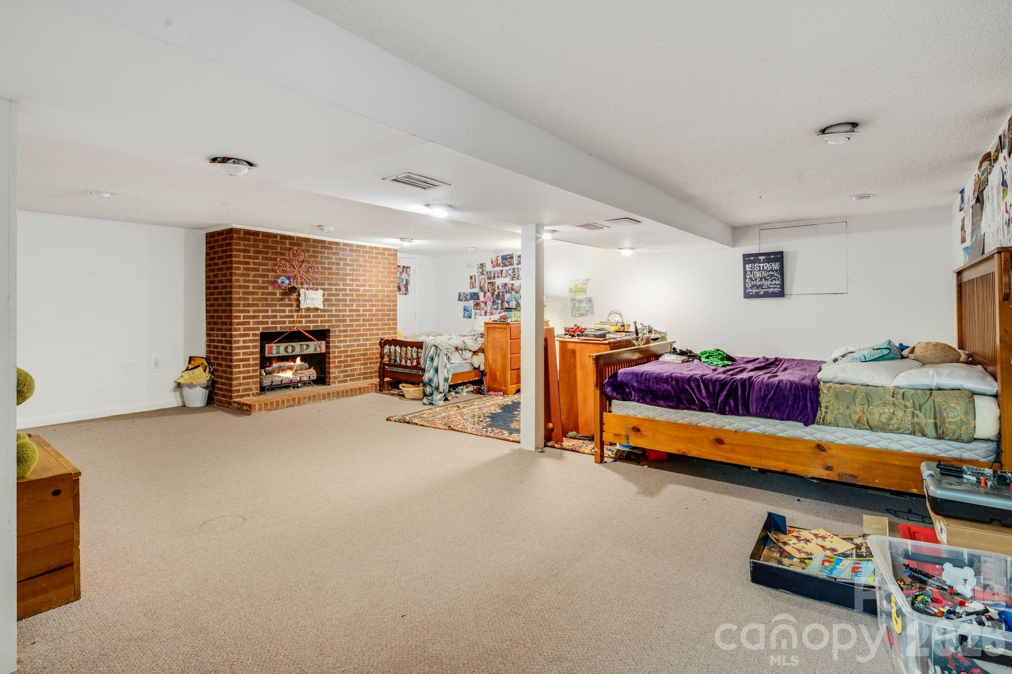 1737 Whiteside Road Forest City, NC 28043 - Photo 28 of 48 a bed room with furniture and a flat screen tv