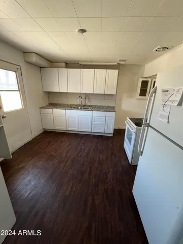 a view of wooden floor and windows in a room