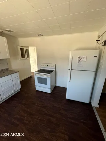 a view of a kitchen with appliances and cabinets