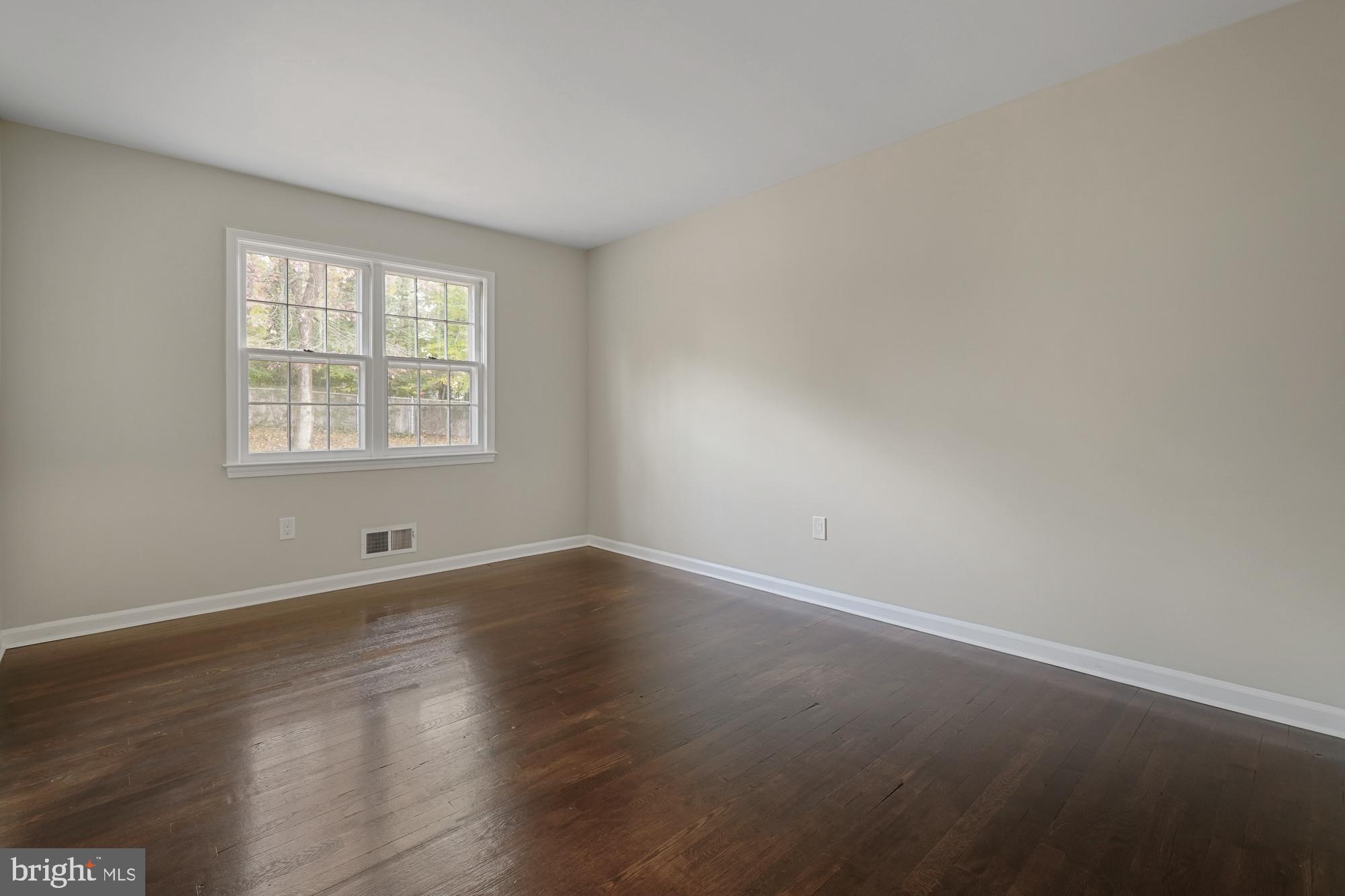 12539 Heurich Road Silver Spring, MD 20902 - Photo 24 of 46 an empty room with wooden floor and windows