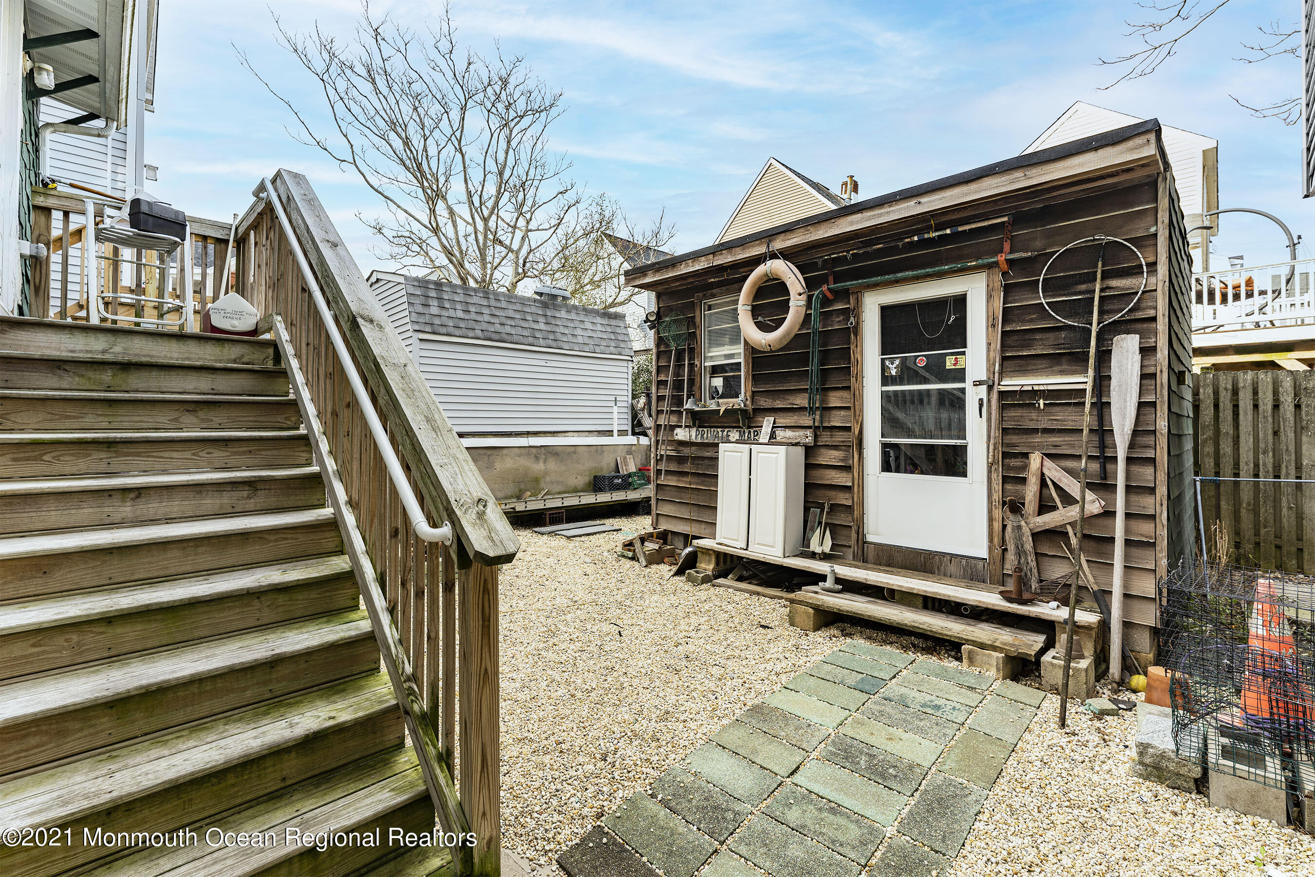 17 Center Street Sea Bright, NJ 07760 - Photo 17 of 23 a view of a house with a large window and wooden fence