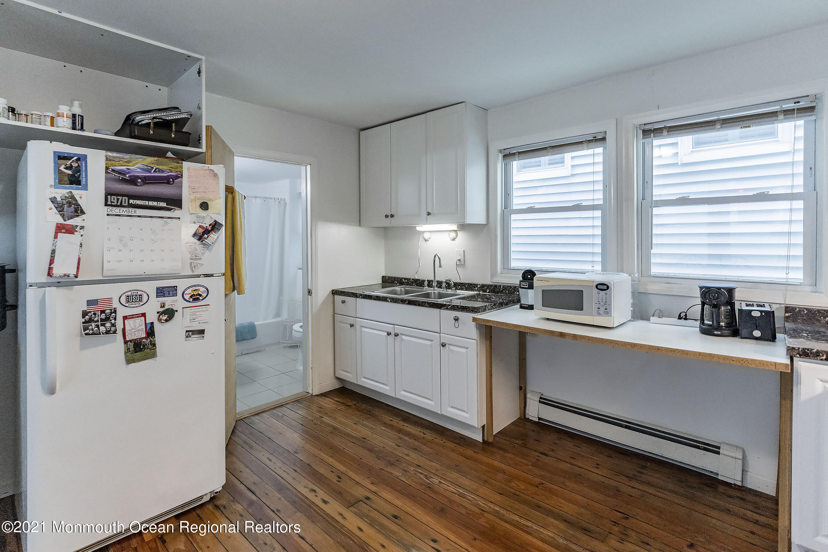 17 Center Street Sea Bright, NJ 07760 - Photo 7 of 23 a kitchen with stainless steel appliances a refrigerator a sink and wooden floors
