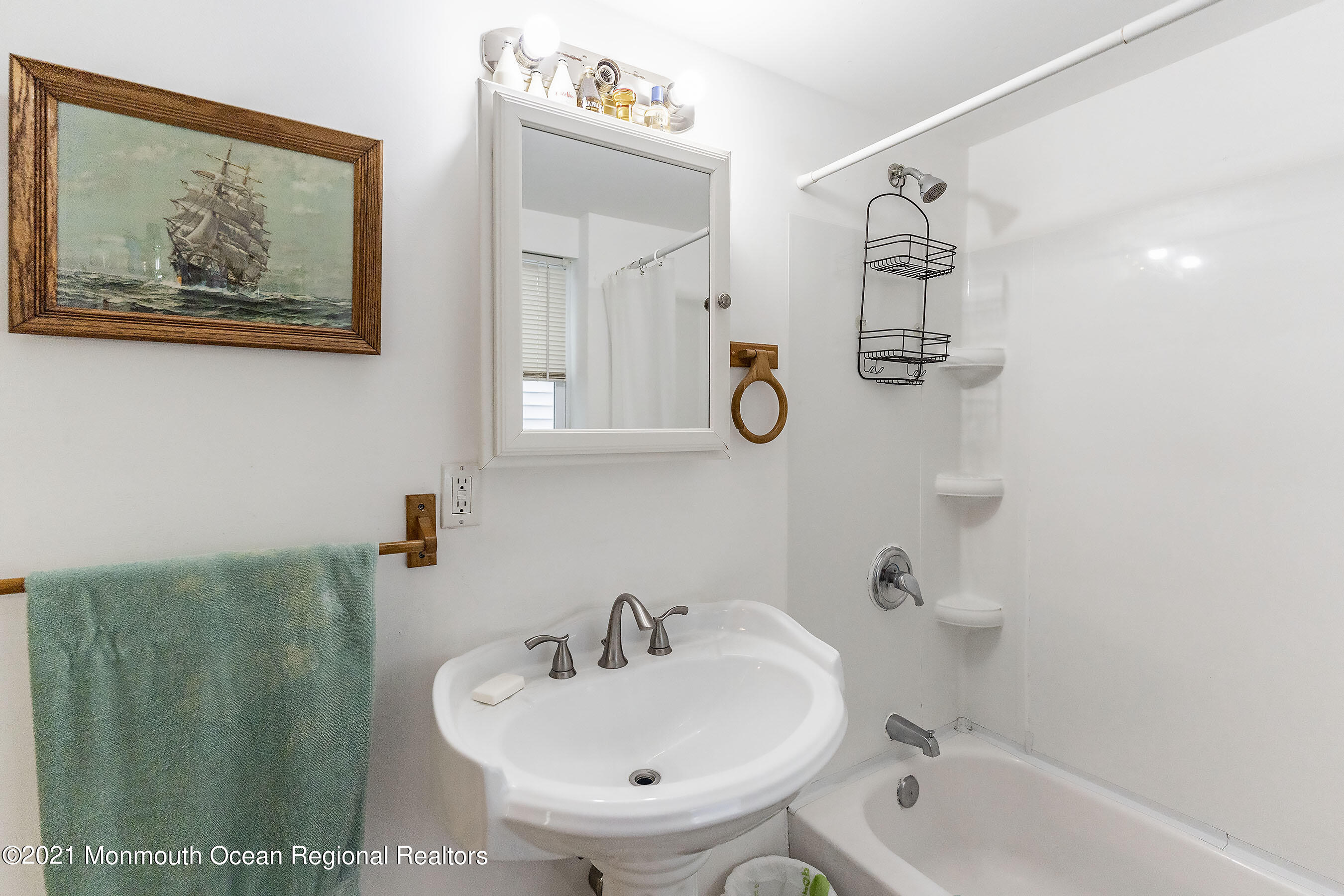 17 Center Street Sea Bright, NJ 07760 - Photo 9 of 23 a bathroom with a sink and mirror with bathtub
