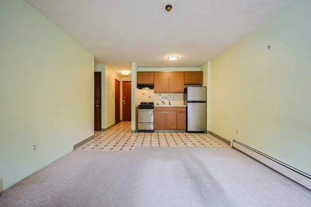 a view of a kitchen with a sink and a refrigerator