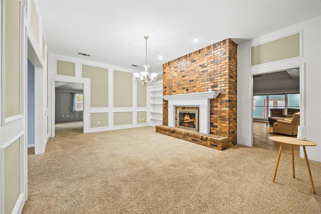 909 Valley View Avenue Red Oak, TX 75154 - Photo 7 of 37 an empty room with windows fire place and fireplace